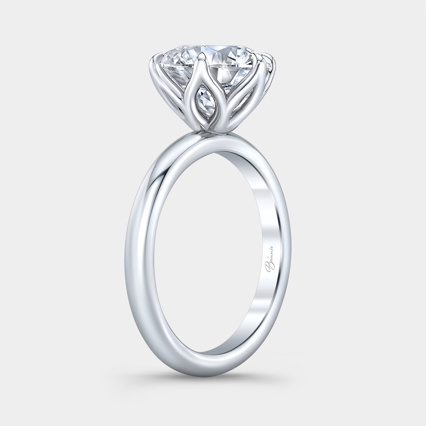 Platinum diamond ring on hand, round tulip.