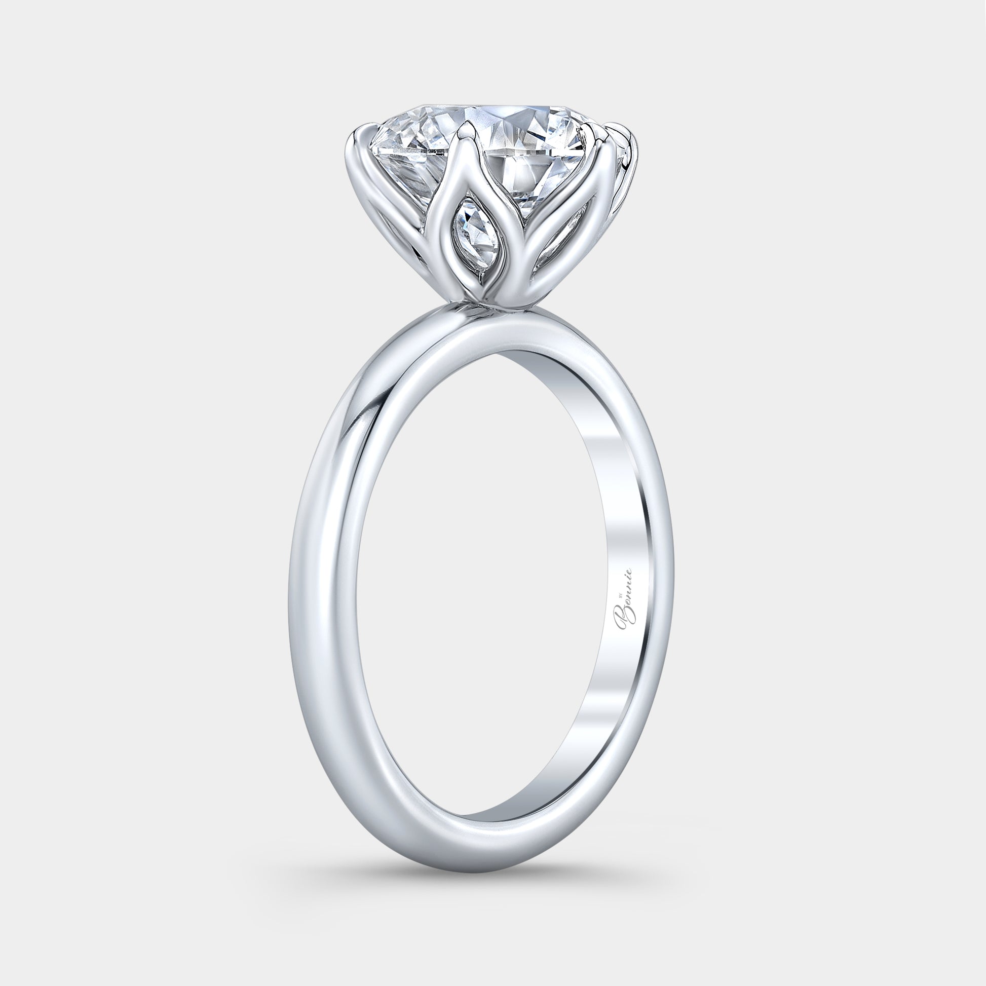 Platinum diamond ring on hand, round tulip.