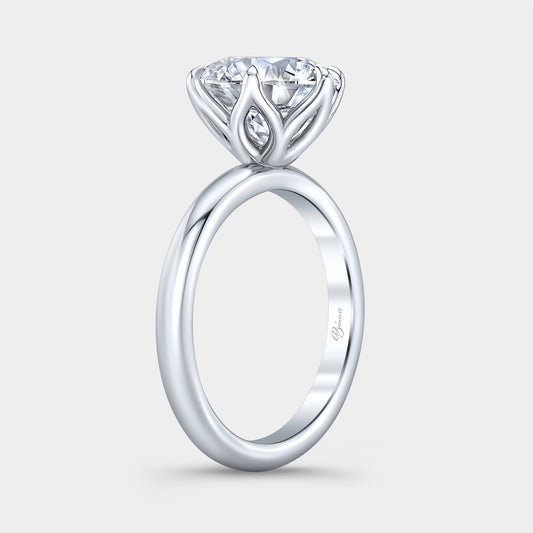 Platinum diamond ring on hand, round tulip.