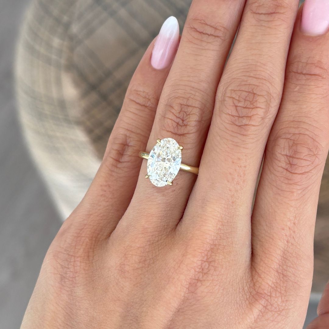 Video of oval diamond yellow gold ring featuring double hidden halo detail