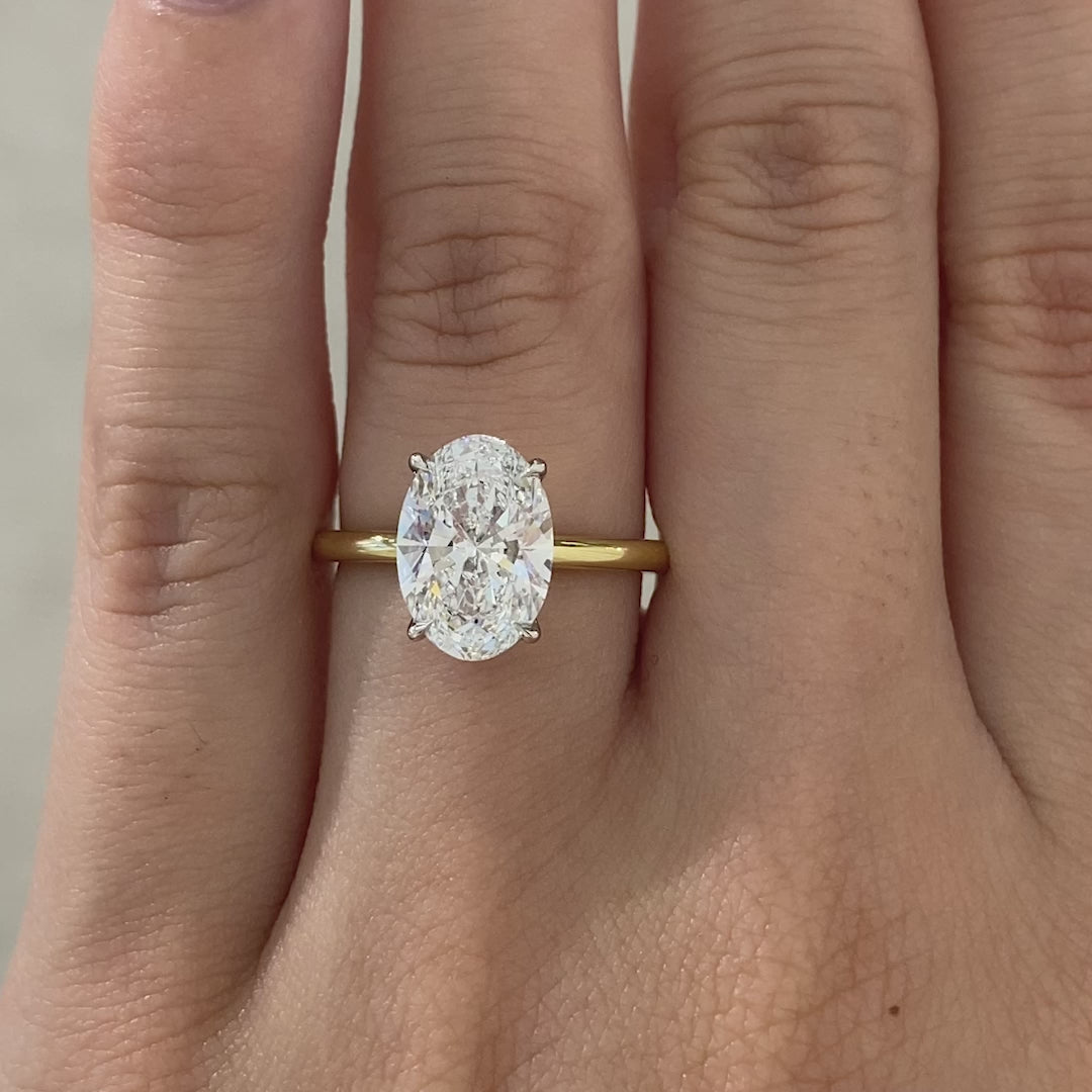Oval ring video, worn on hand, solitaire setting.