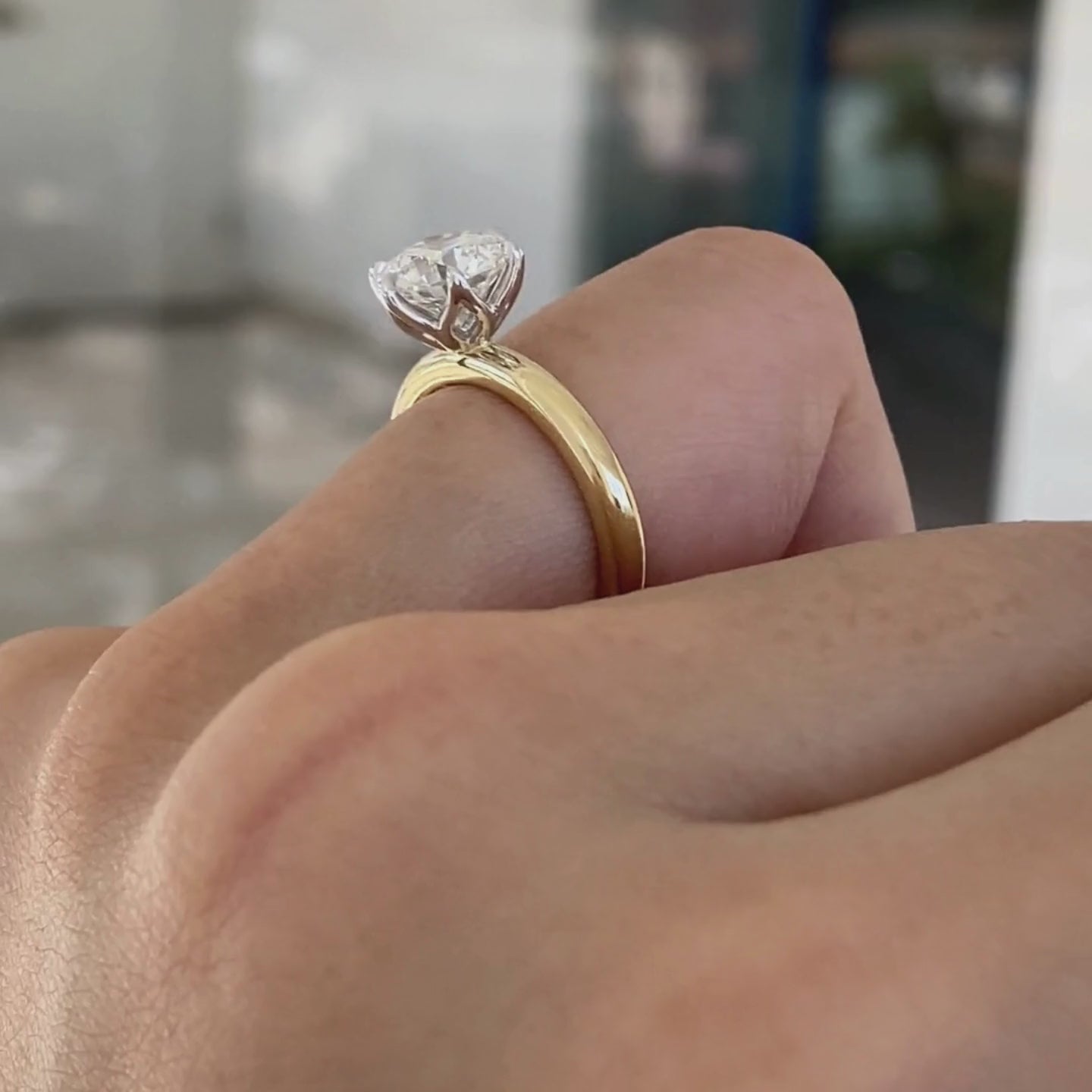 Round ring video, worn on hand, tulip setting.