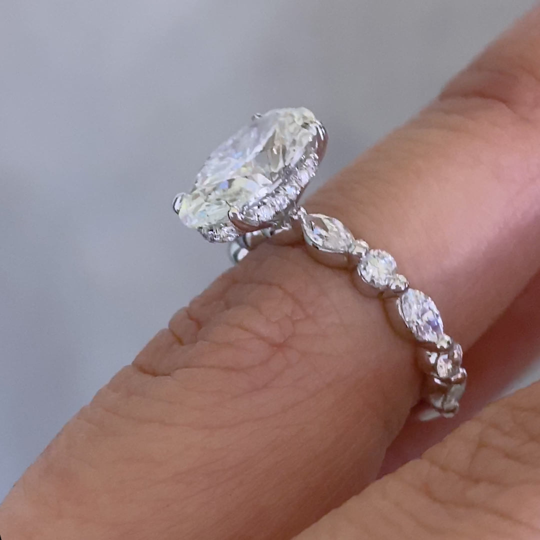 White gold ring video, oval diamond, shared prong settings, and halo details.