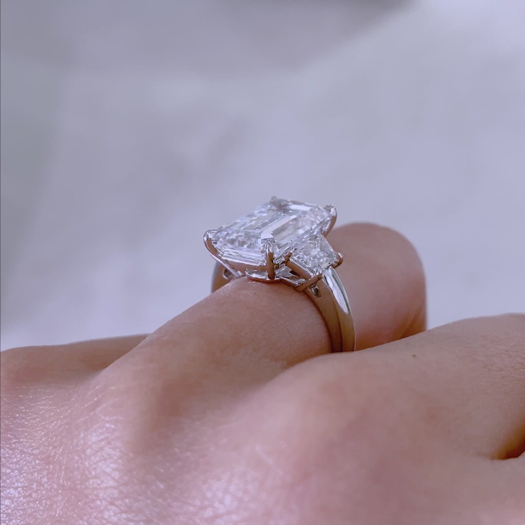 Emerald ring video, worn on hand, trapezoid sides.