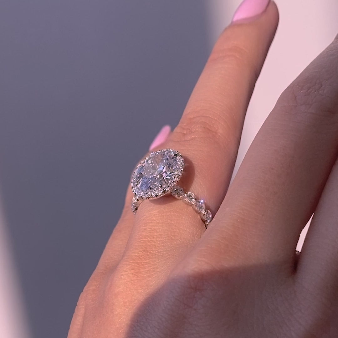 Video of a 3ct oval diamond engagement ring with halo and diamond band.