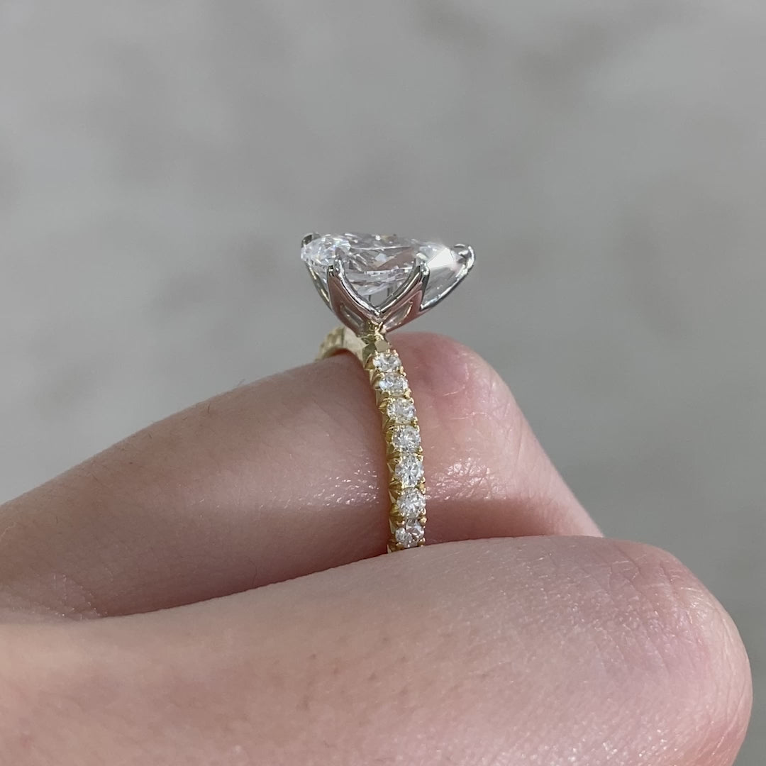 Pear ring video, worn on hand, tulip pave setting.