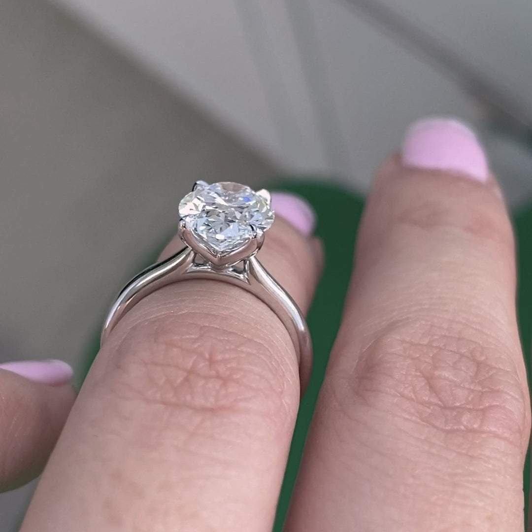 White gold ring video, oval diamond, cathedral setting, and tulip basket details.