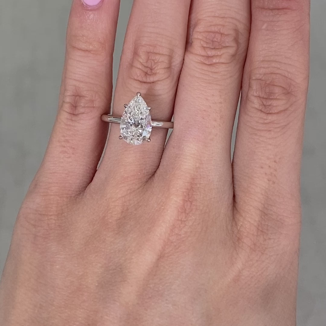 Pear ring video, worn on hand, solitaire setting.
