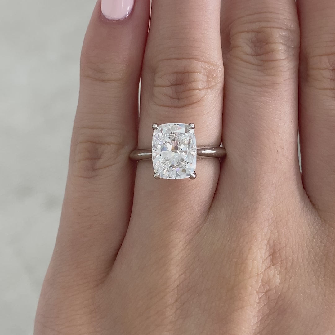 Video of a 3ct cushion diamond engagement ring with tulip setting and knife edge band.