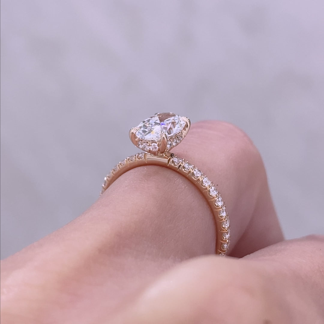 Oval ring video, worn on hand, pave setting.