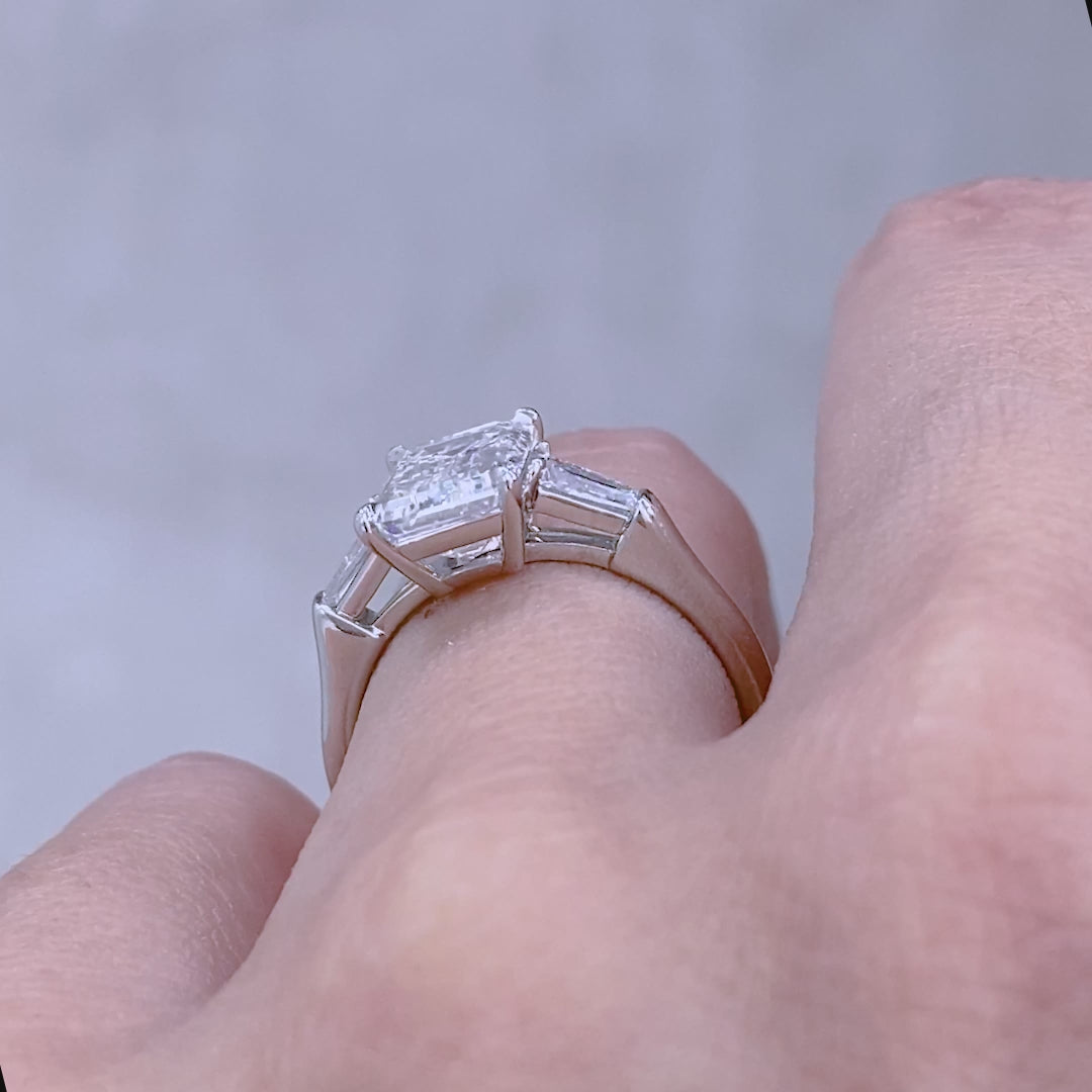 Emerald ring video, worn on hand, baguette sides.