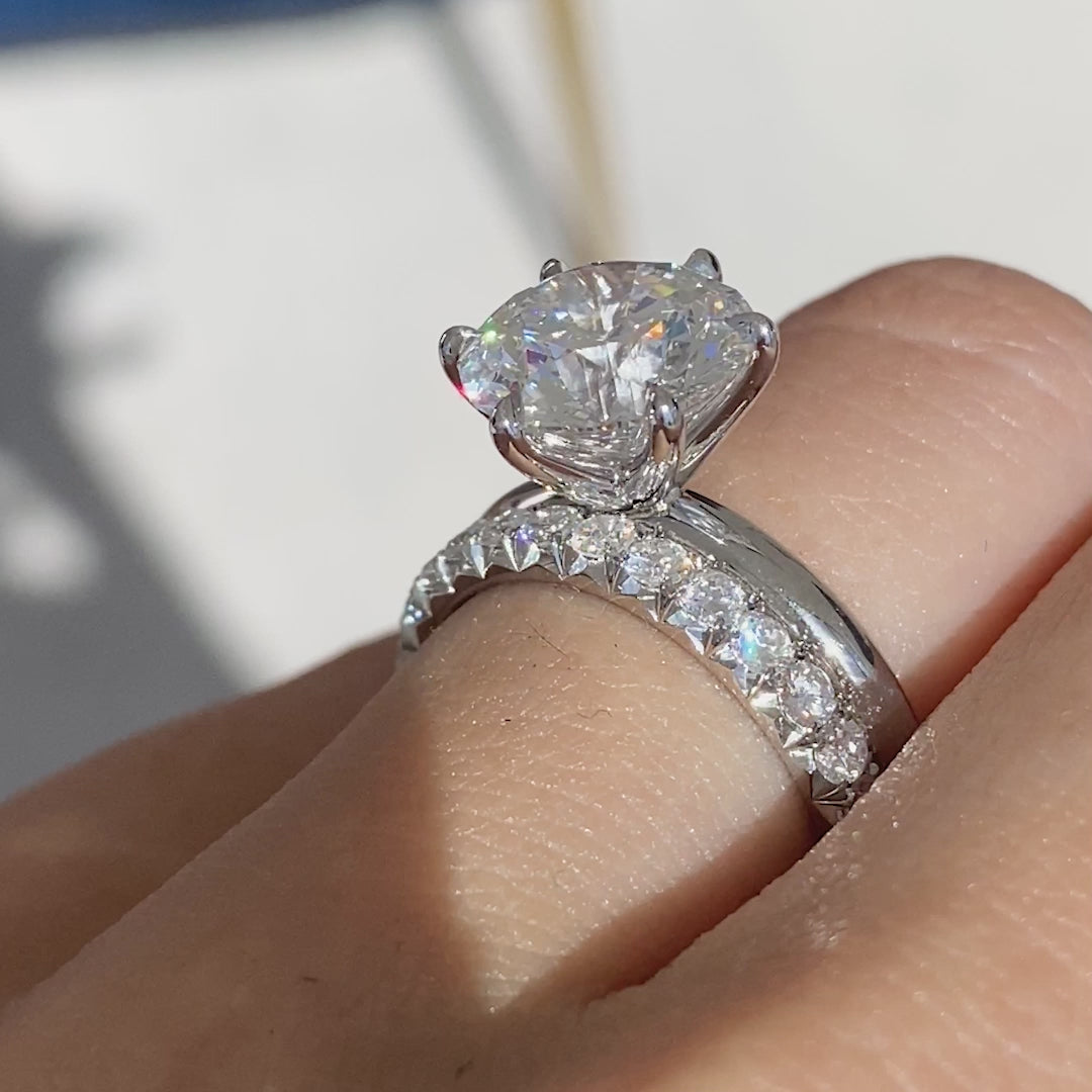 Hand with pave diamond platinum band.
