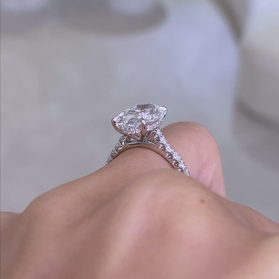 Video of a 2ct oval diamond engagement ring with hidden halo and French pave.