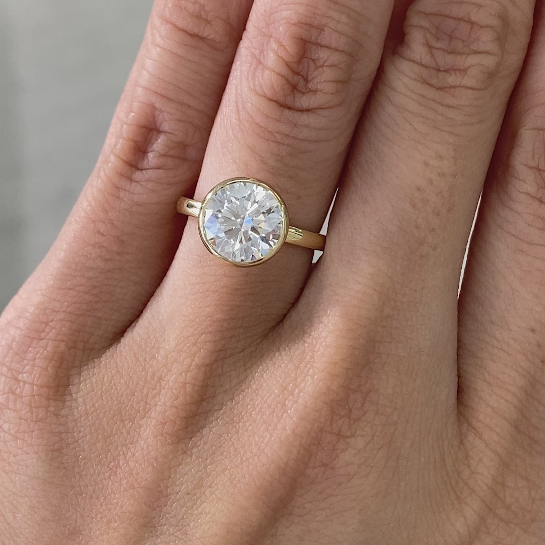 Round ring video, worn on hand, tulip bezel setting.