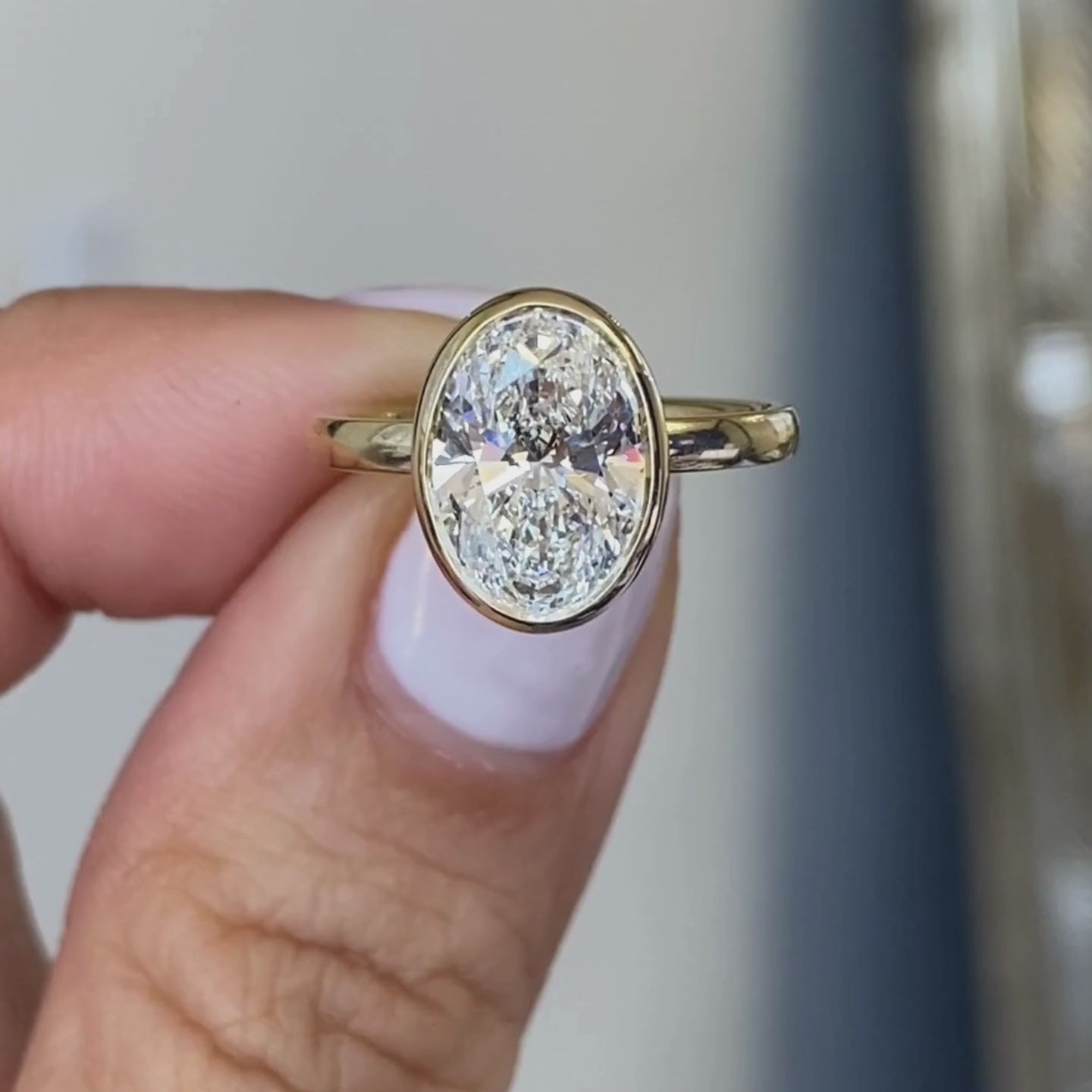 Oval ring video, worn on hand, bezel tulip setting.