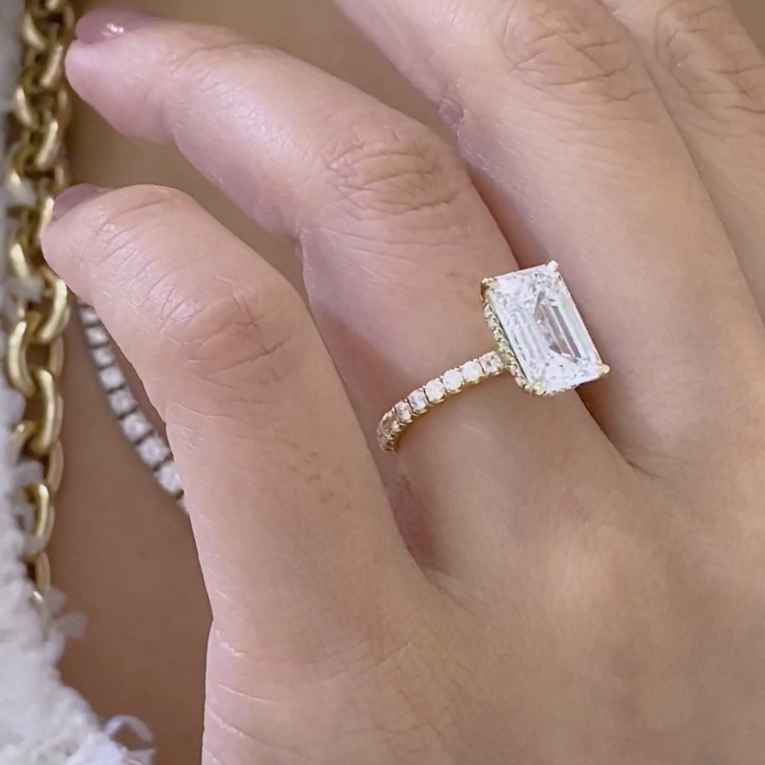 Emerald ring video, worn on hand, U pave band.