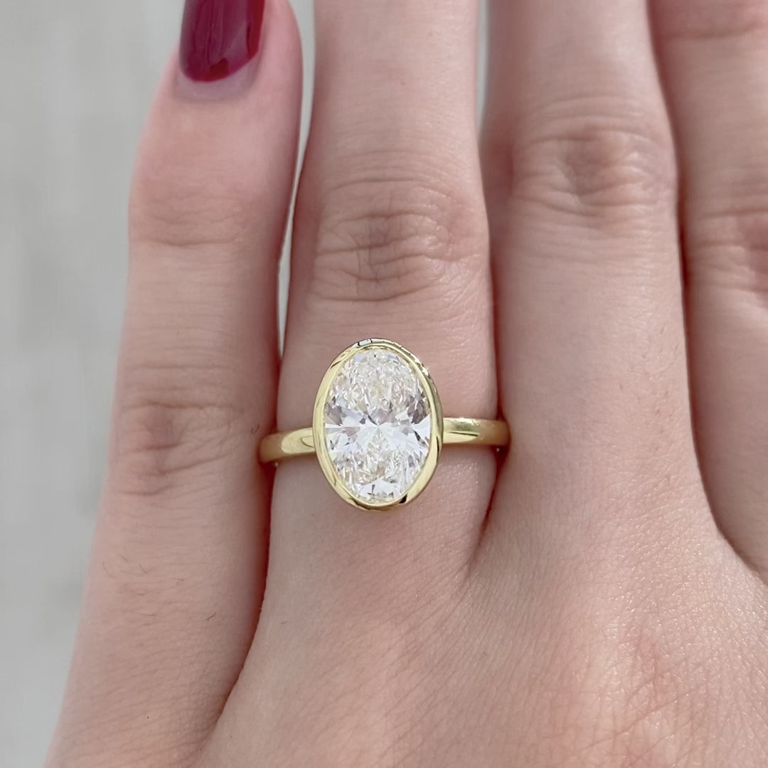 Oval ring video, worn on hand, bezel tulip setting.