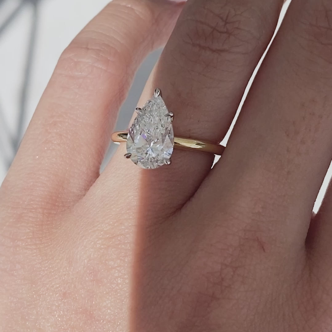 Pear ring video, worn on hand, solitaire setting.