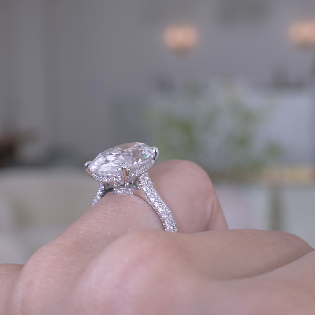 White gold ring video, oval diamond, pave setting, and halo details.