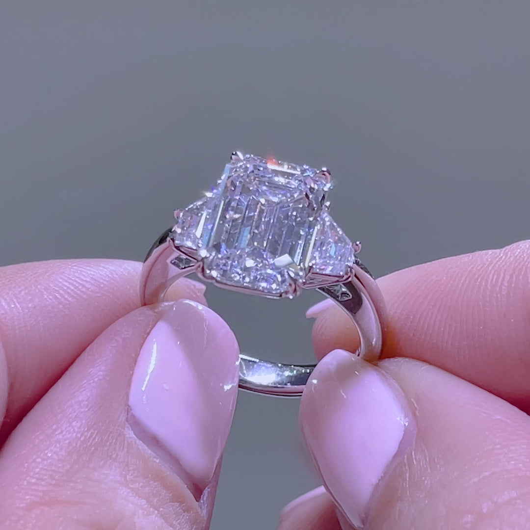 Emerald ring video, worn on hand, trapezoid sides.