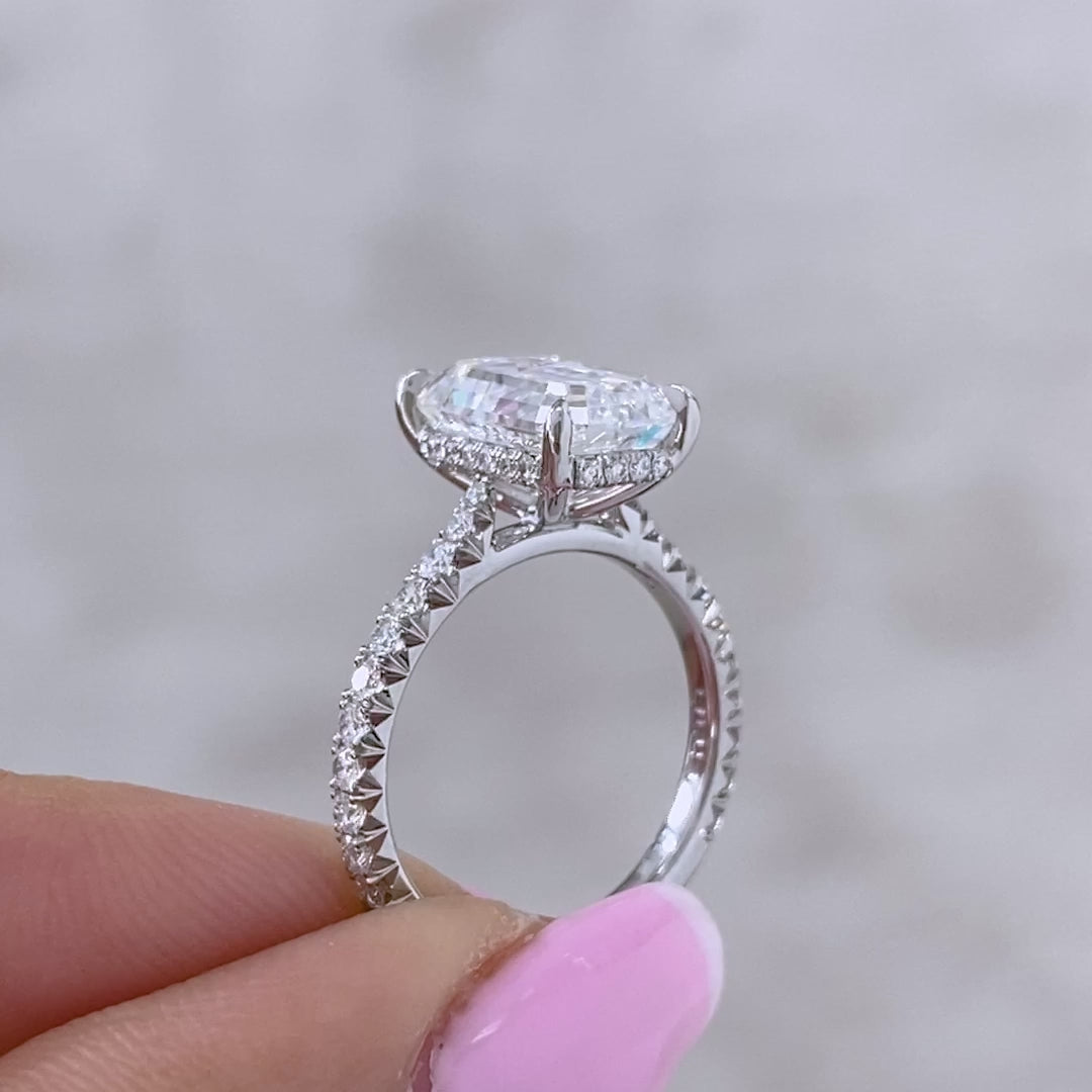 Video of a 4ct emerald diamond engagement ring with extra low profile, hidden halo, and U pave.