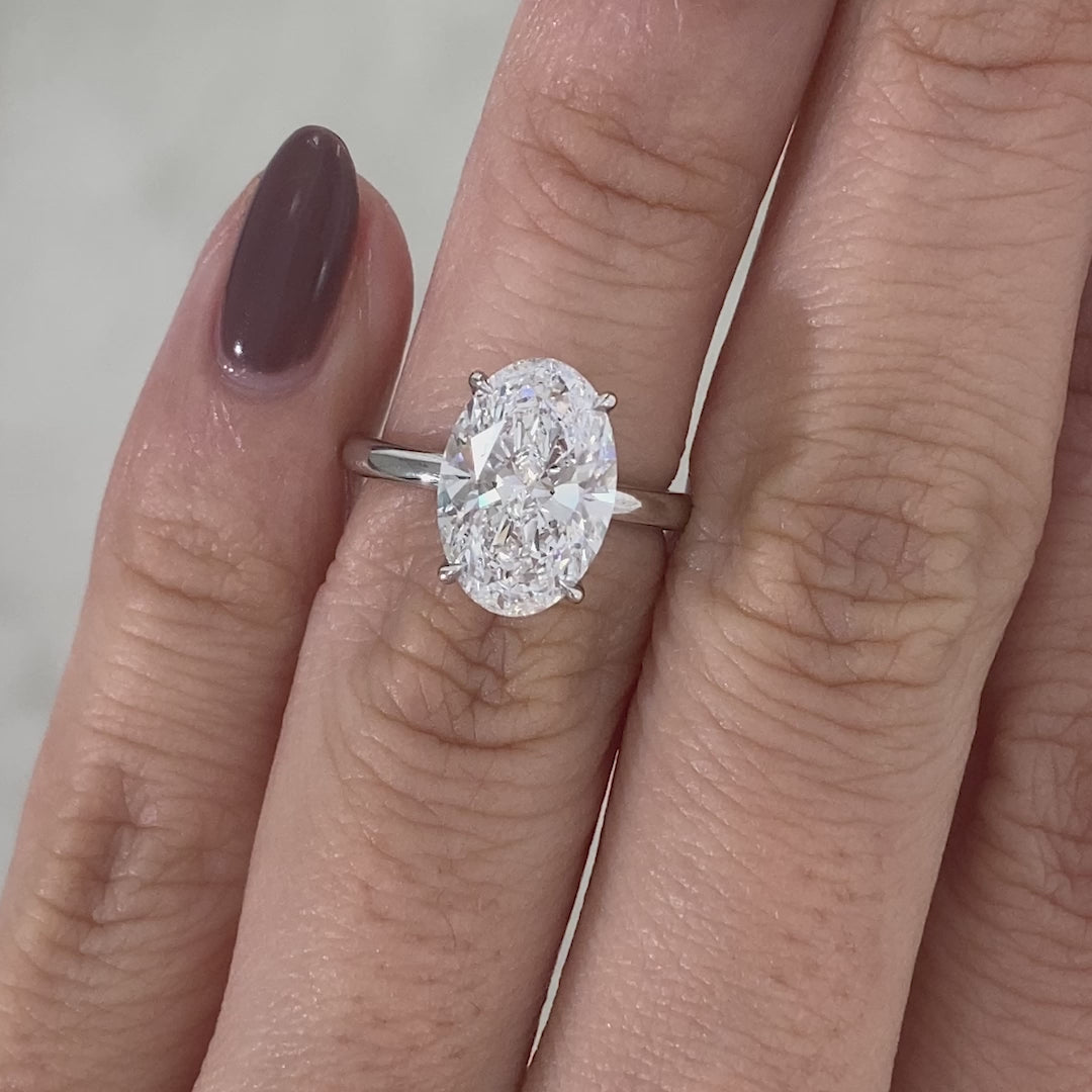 Oval ring video, worn on hand, solitaire setting.