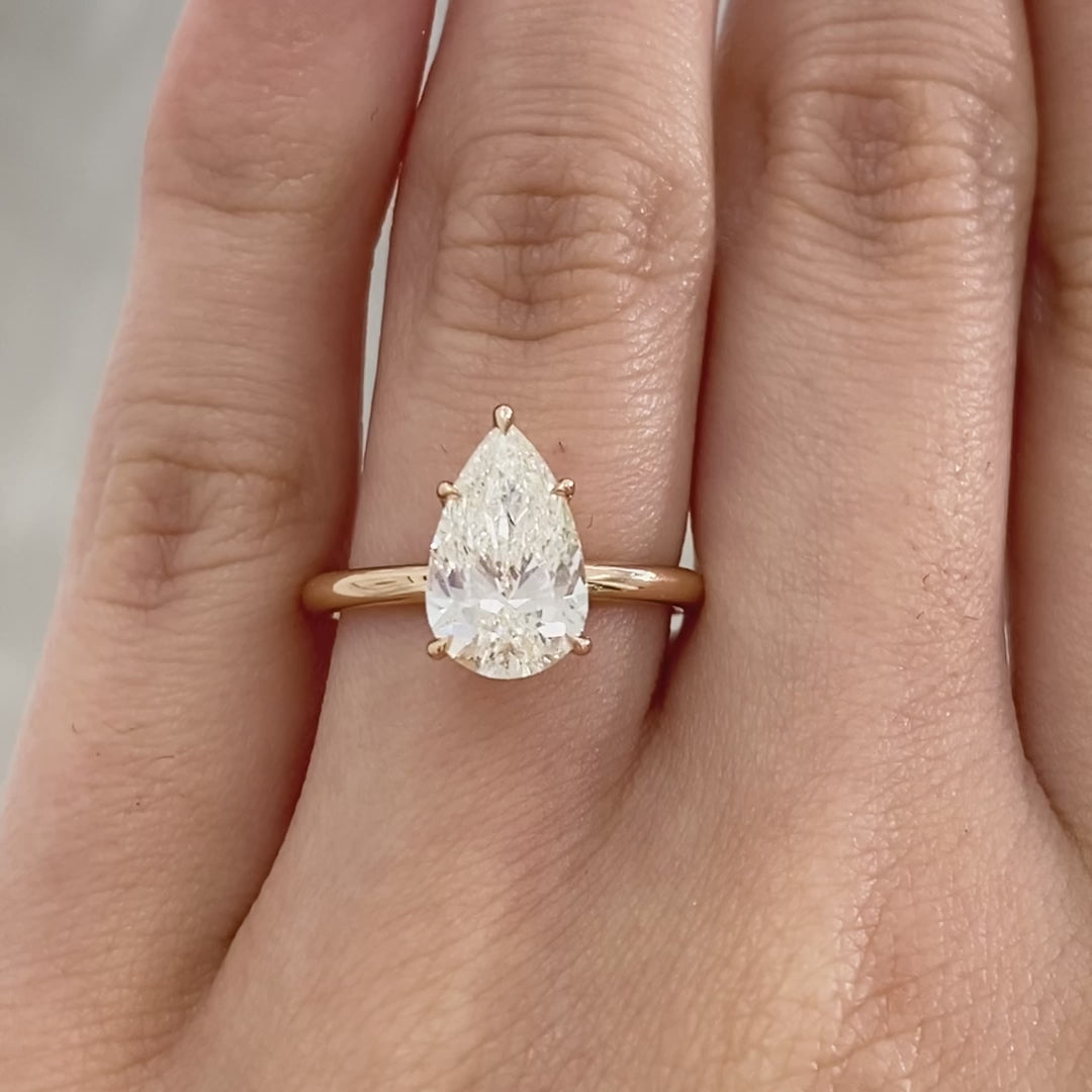 Pear ring video, worn on hand, solitaire setting.