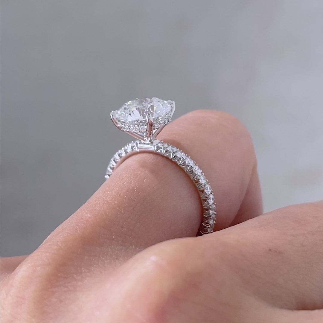 White gold ring video, round diamond, 4 prong setting, and pave details.