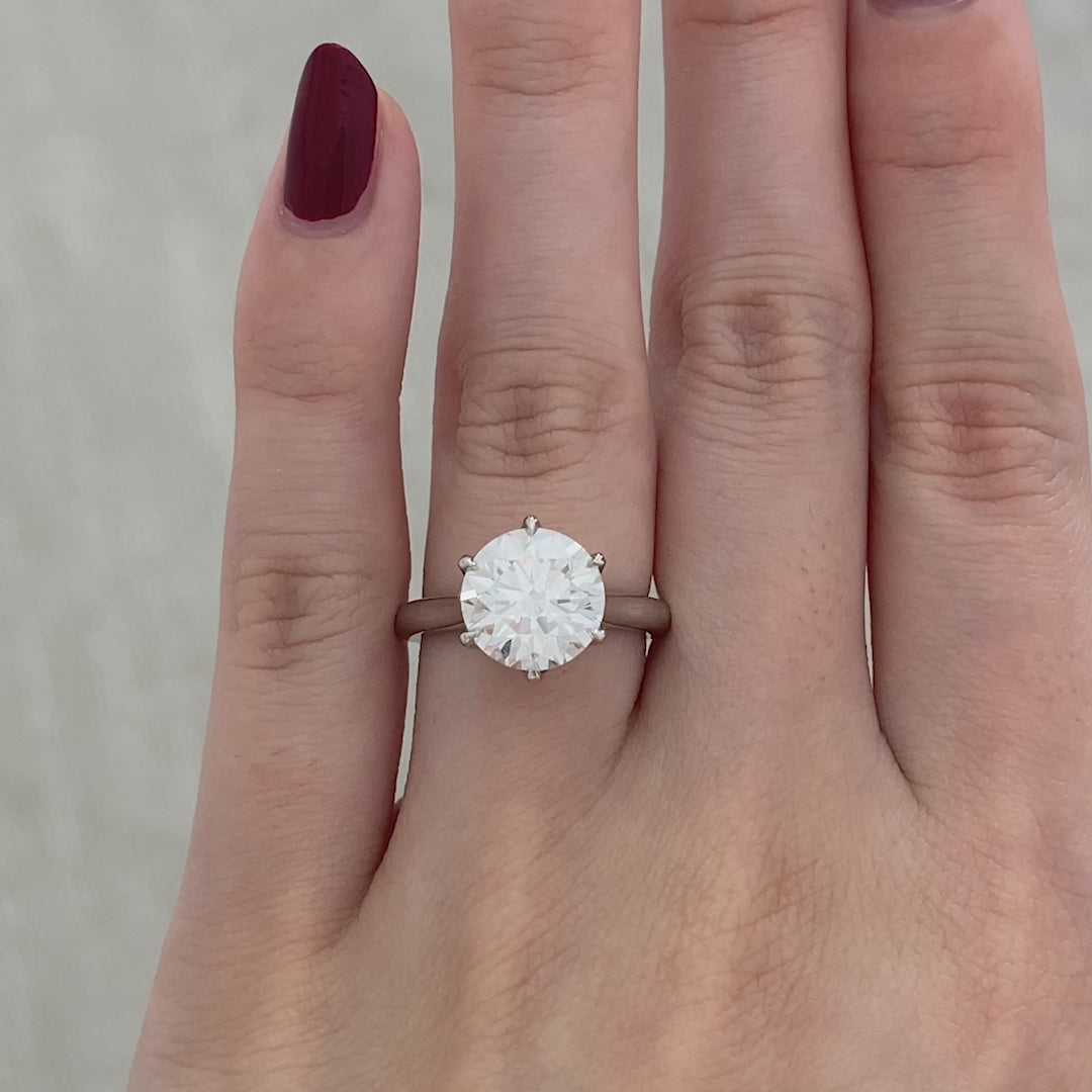 White gold ring video, round diamond, tapered cathedral, and tulip basket details.