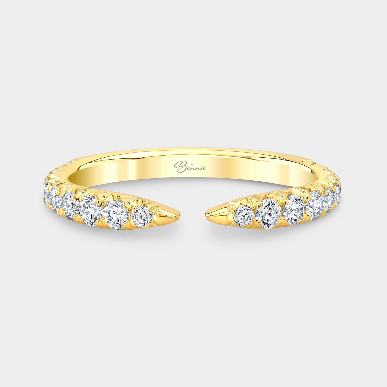 Yellow gold wedding band with round diamonds, French pave, open claw setting.