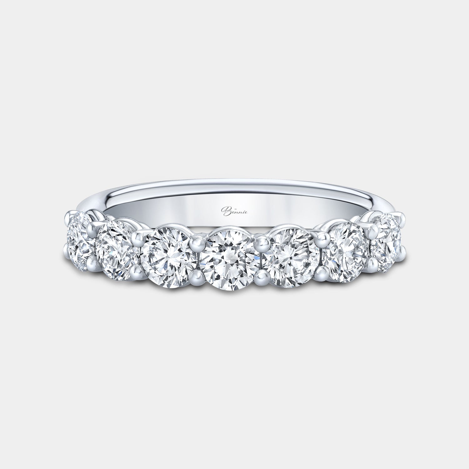 Platinum wedding band, round diamonds, shared prong setting.