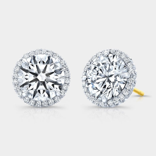 Pair of diamond stud earrings on a light gray background
