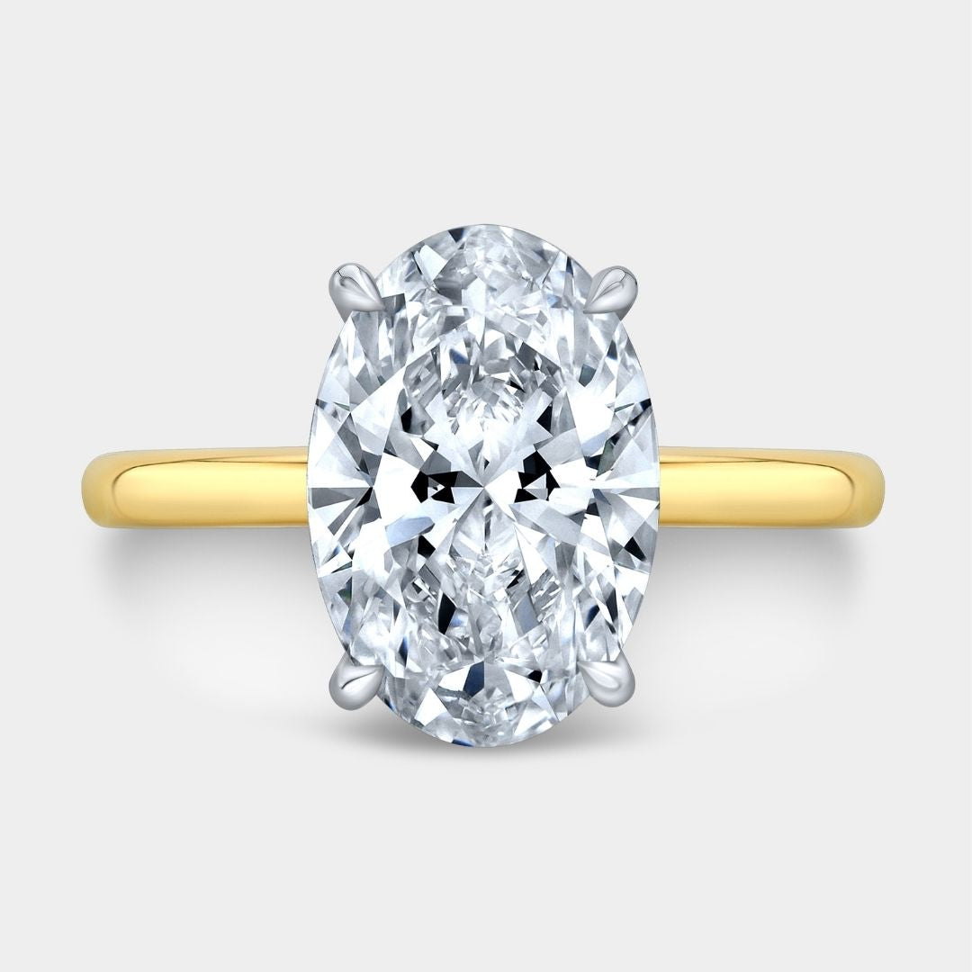 Gold ring with a large diamond on a light gray background