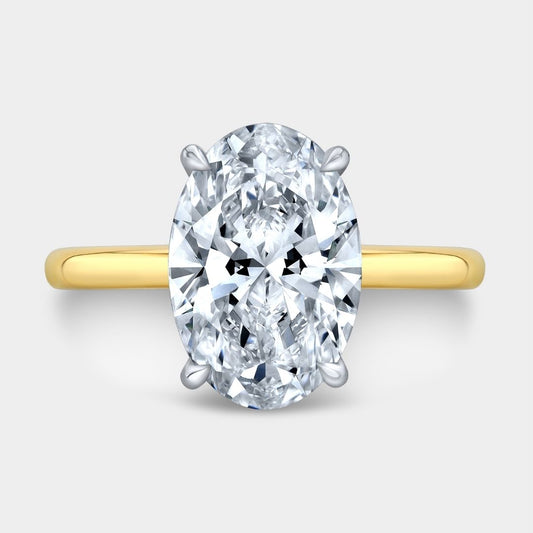 Gold ring with a large diamond on a light gray background