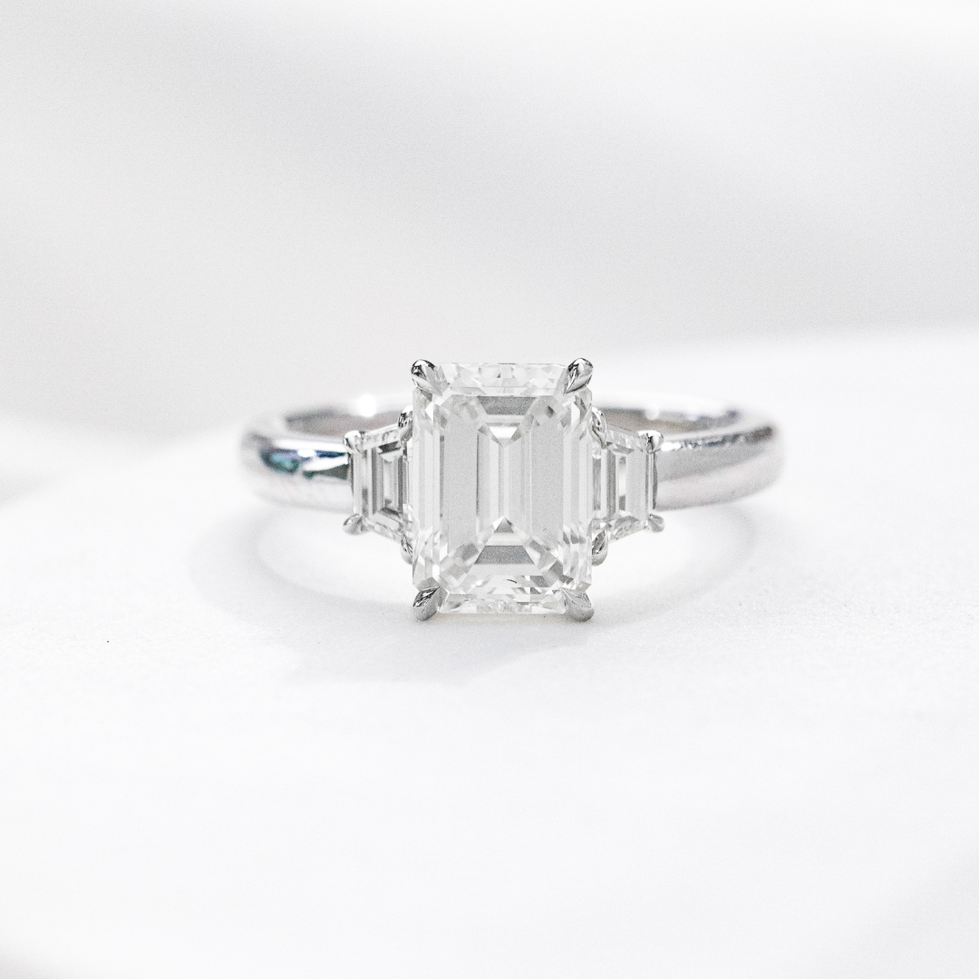 2.06ct lab grown emerald cut diamond 3 stone platinum engagement ring with trapezoid sides