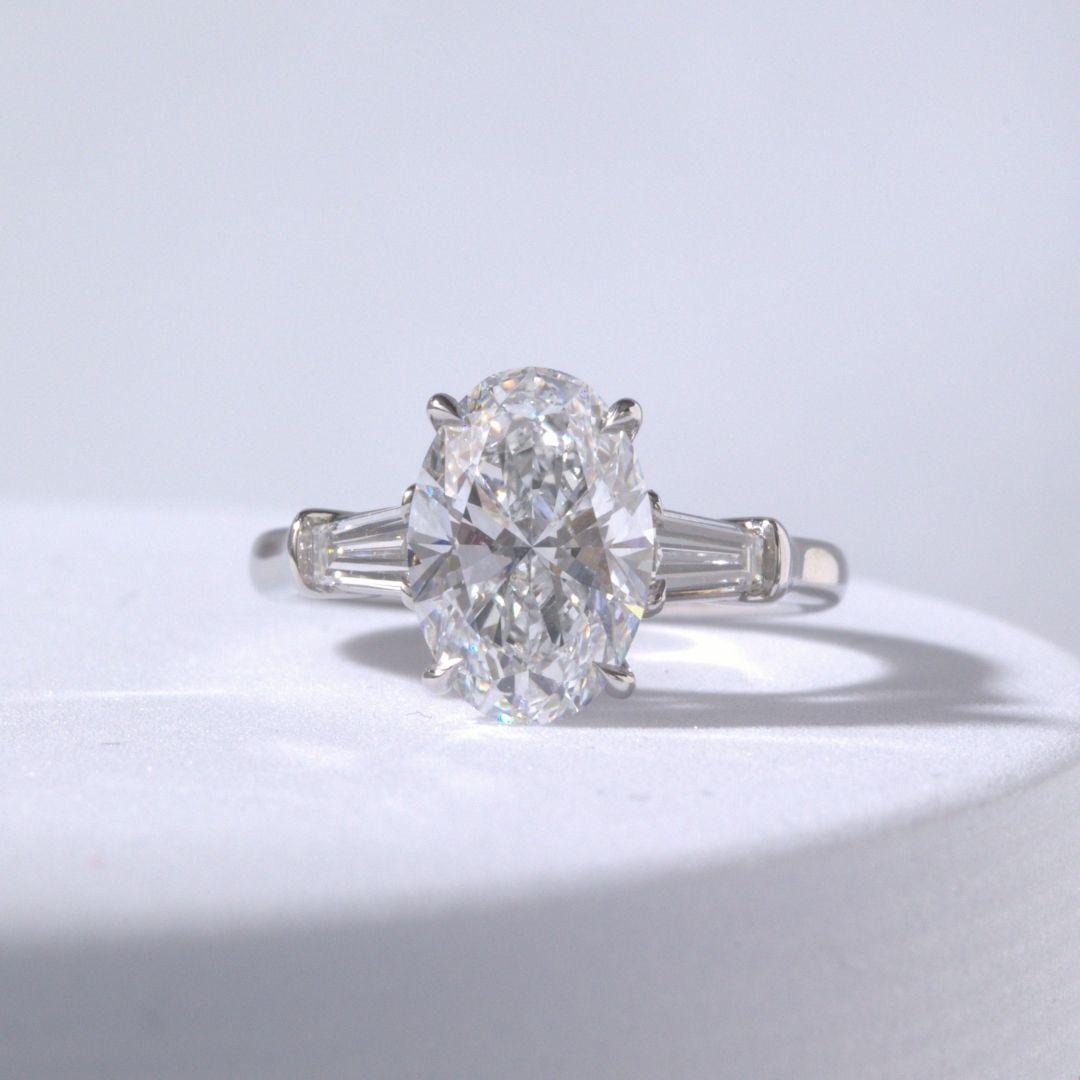 Oval Diamond 3 Stone Ring with Tapered Baguette Side Stones Platinum Engagement Ring