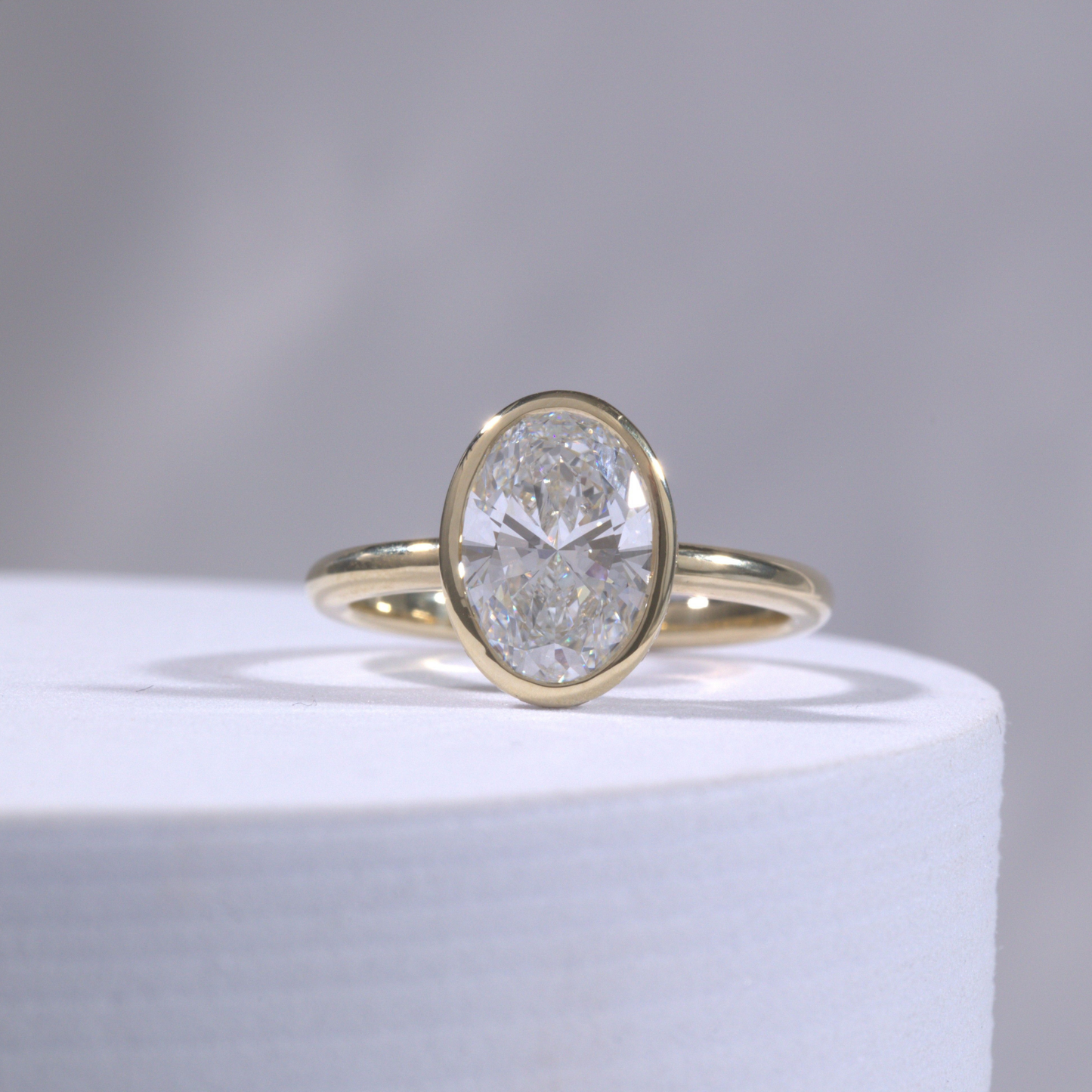 Oval Diamond Hidden Halo Bezel Set Solitaire Yellow Gold Engagement Ring