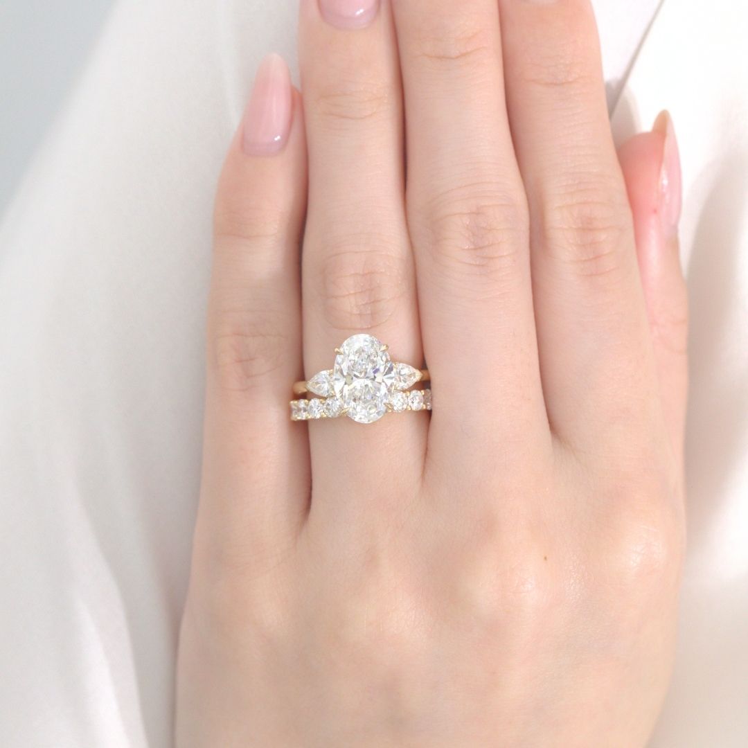 Oval Diamond Hidden Halo with Pear Shape Side Stones Yellow Gold Engagement Ring