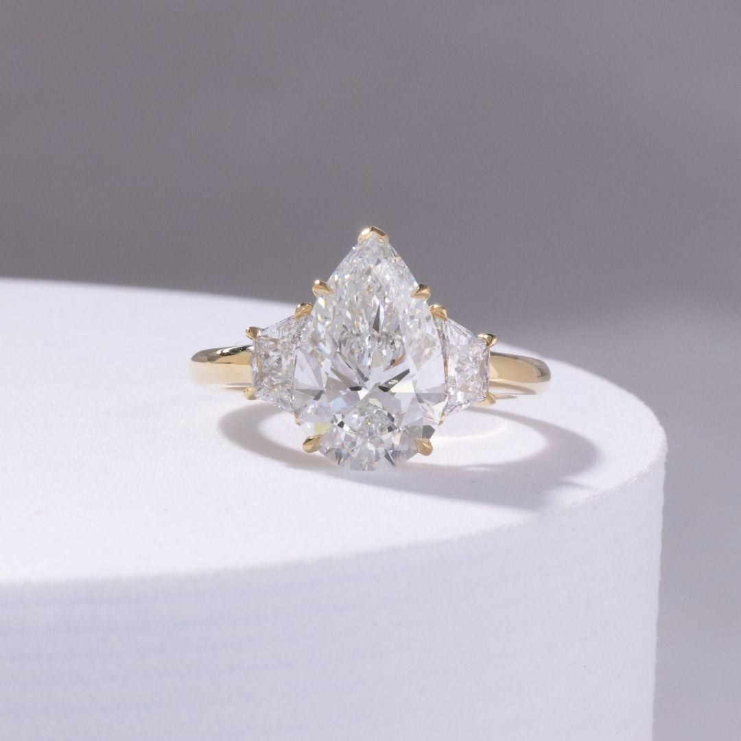 4ct Pear Shape Diamond with Trapezoid Yellow Gold 3 Stone Ring
