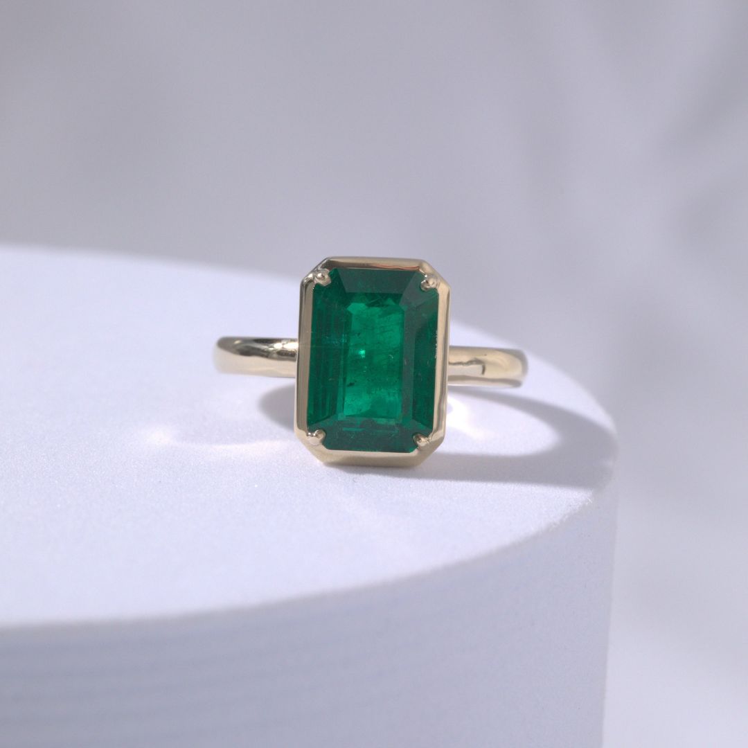 4ct Emerald Cut Green Emerald Mira Bezel Set Yellow Gold Engagement Ring