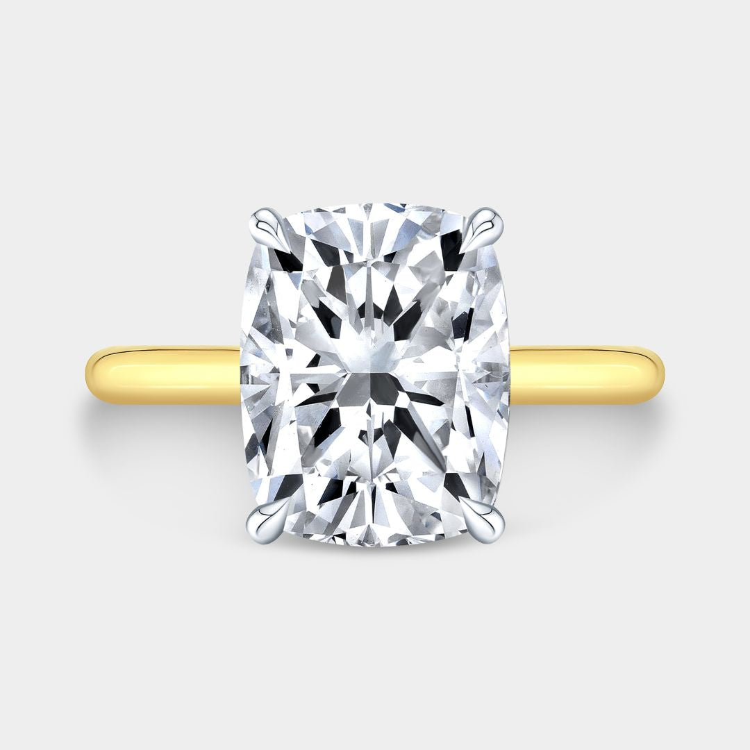 Cushion-cut diamond solitaire ring with hidden halo, yellow gold and platinum