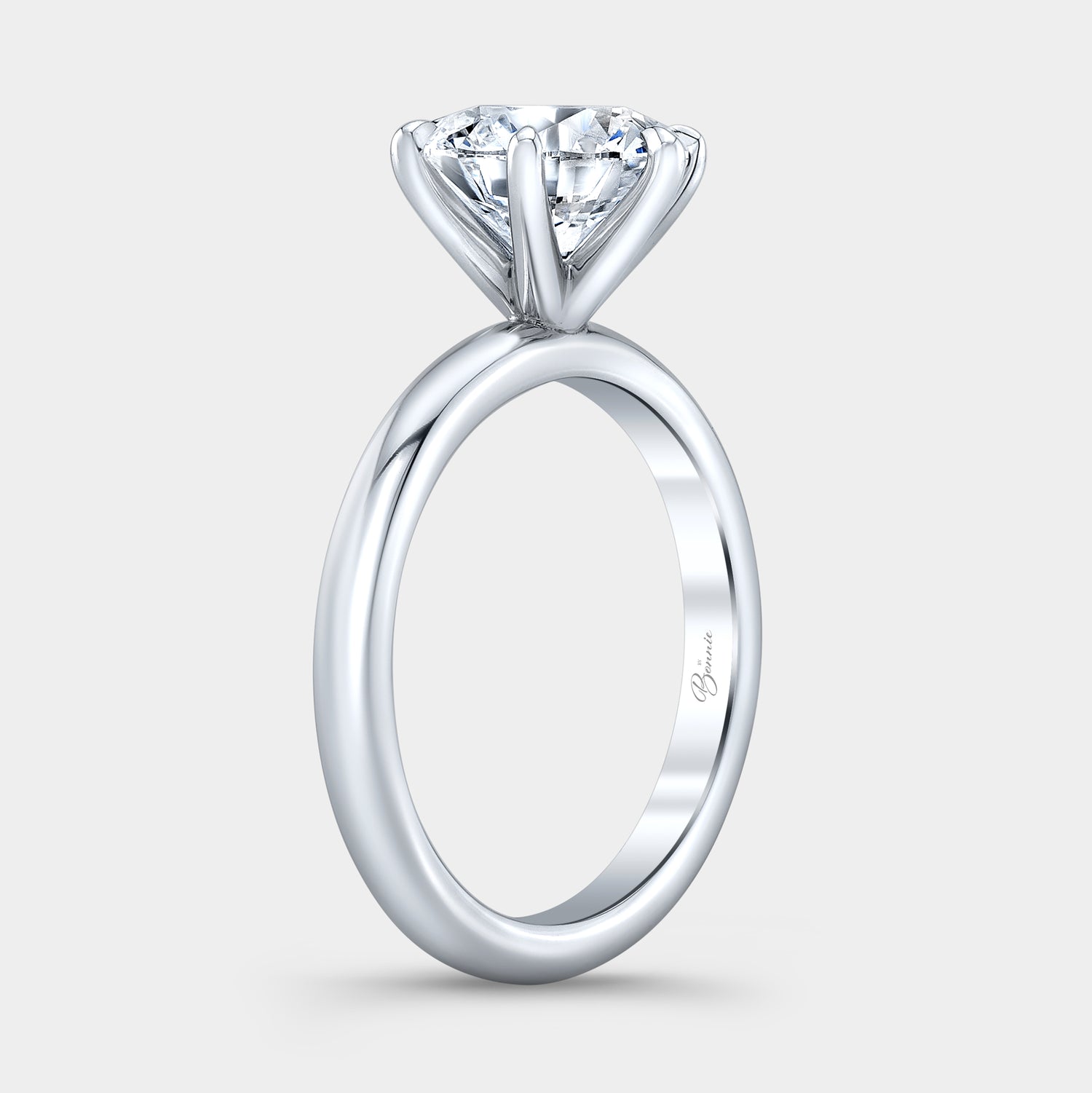 Platinum diamond ring on hand, round solitaire.