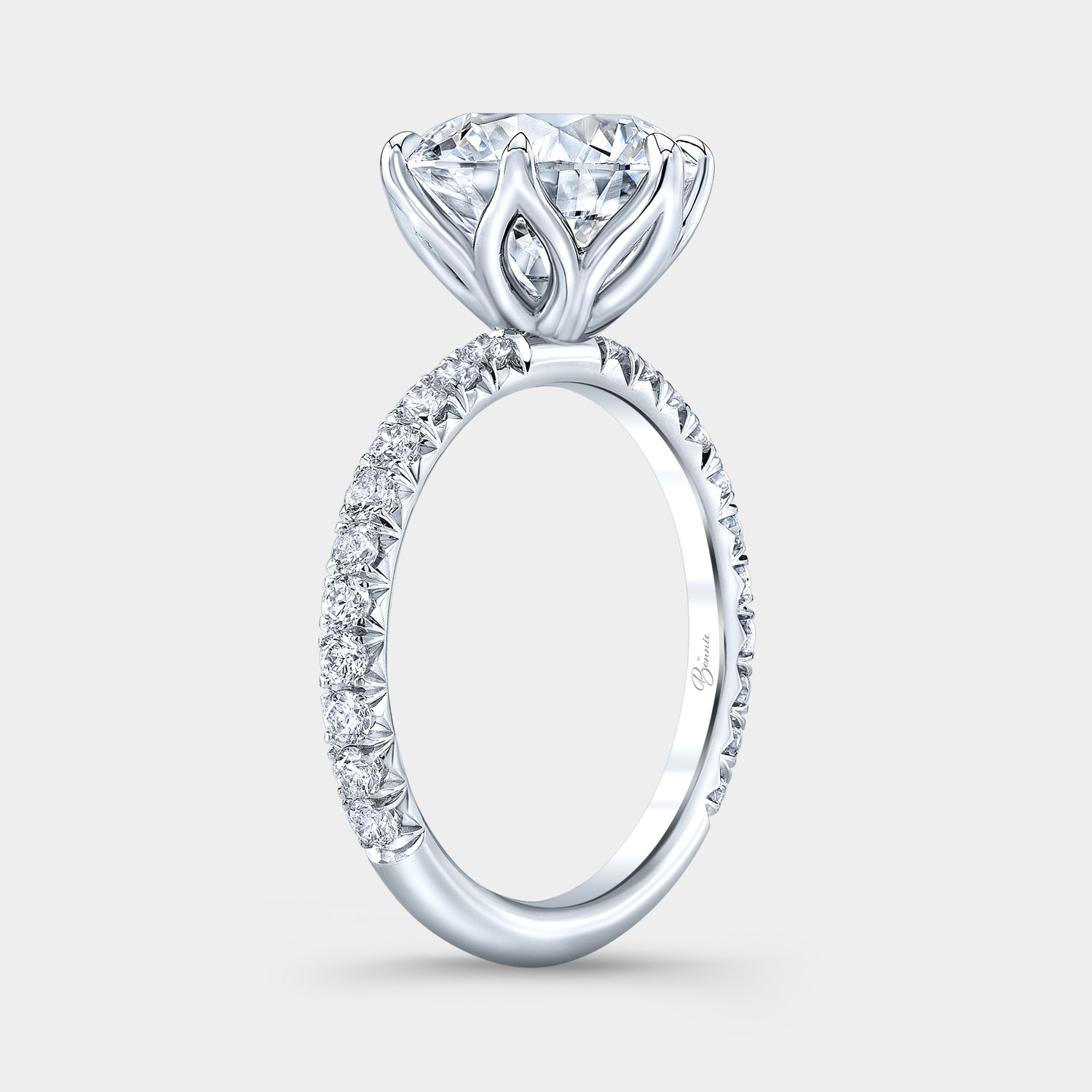 Round diamond ring, tulip setting, French pave band.
