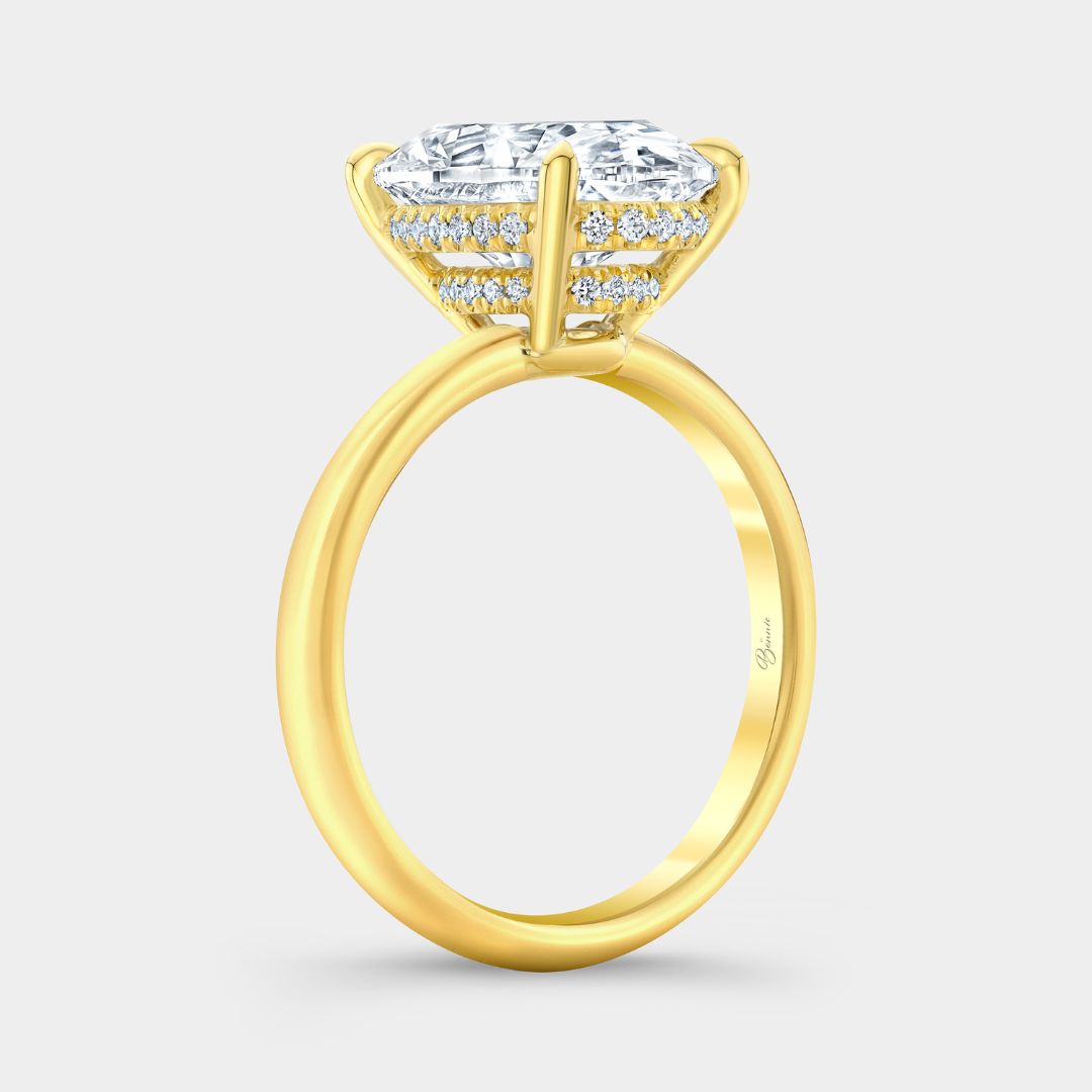 Oval-cut diamond solitaire ring with double hidden halo in yellow gold