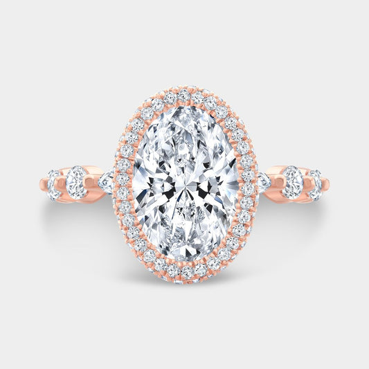 Oval diamond engagement ring with seamless halo and marquise-round accents in rose gold

