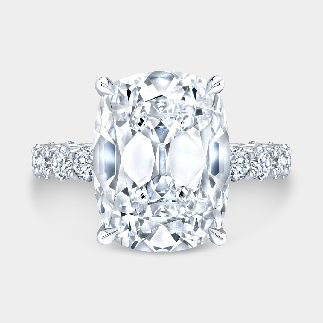 Old mine cushion diamond engagement ring with hidden halo and trellis setting in platinum