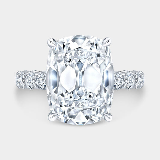 Old mine cushion diamond engagement ring with hidden halo and trellis setting in platinum