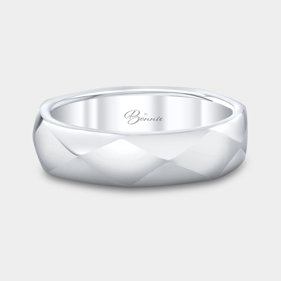 Silver ring with a textured design on a light gray background