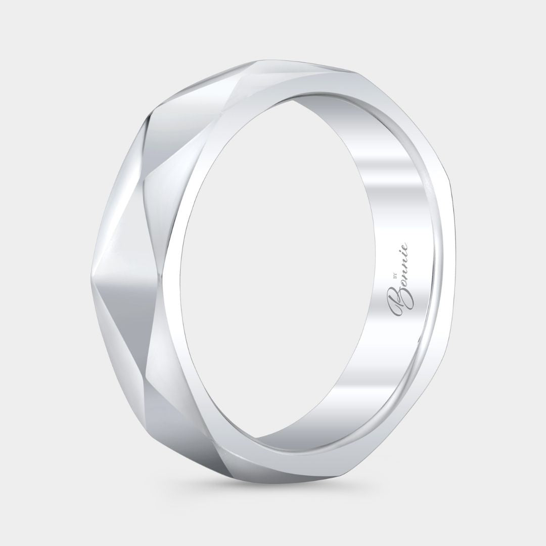 Silver ring with geometric design on a light gray background