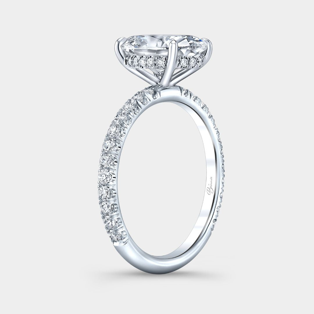 Diamond ring with a clear gemstone on a light gray background